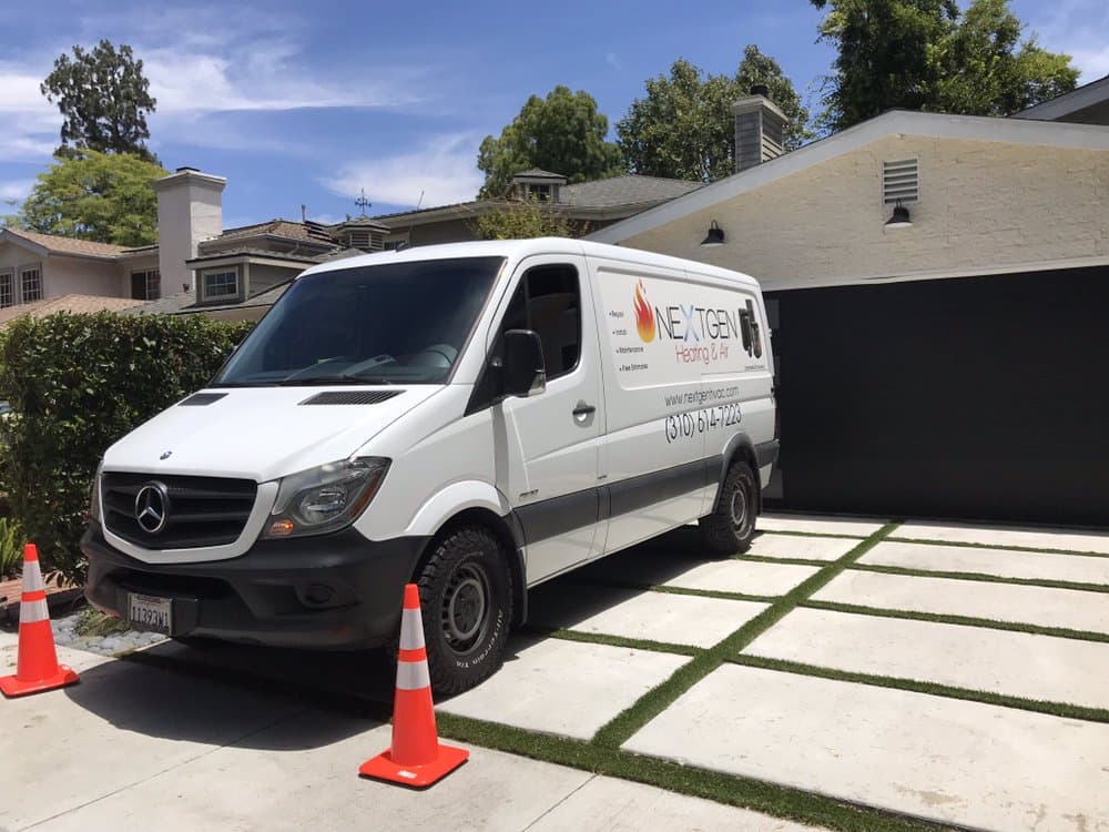 NextGen's wrapped Sprinter van in a client's driveway on a sunny Valley street